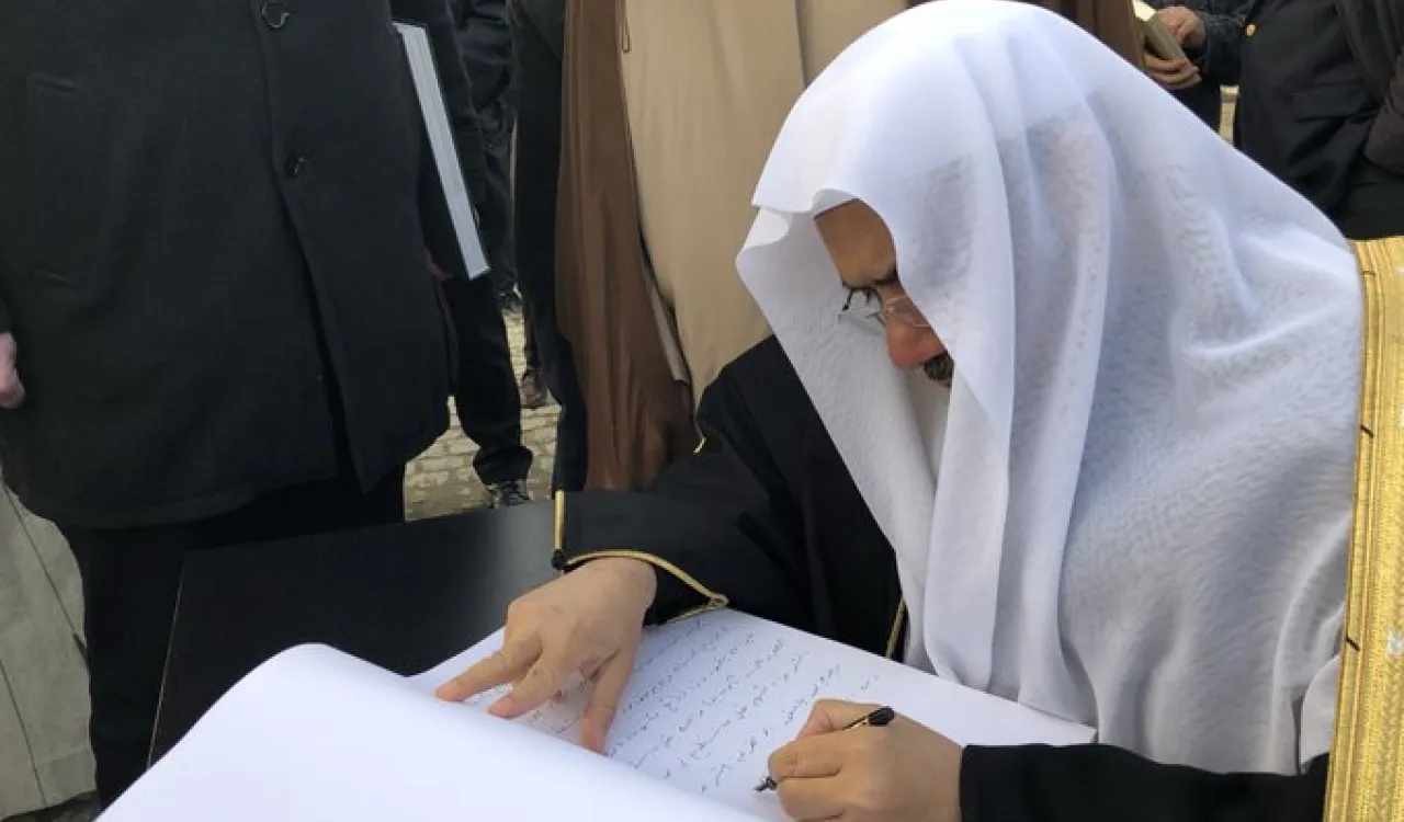 HE Dr. Mohammad Alissa signs the Visitors’ Book at Auschwitz Museum, expressing interfaith solidarity and hopes that such crimes will never be repeated